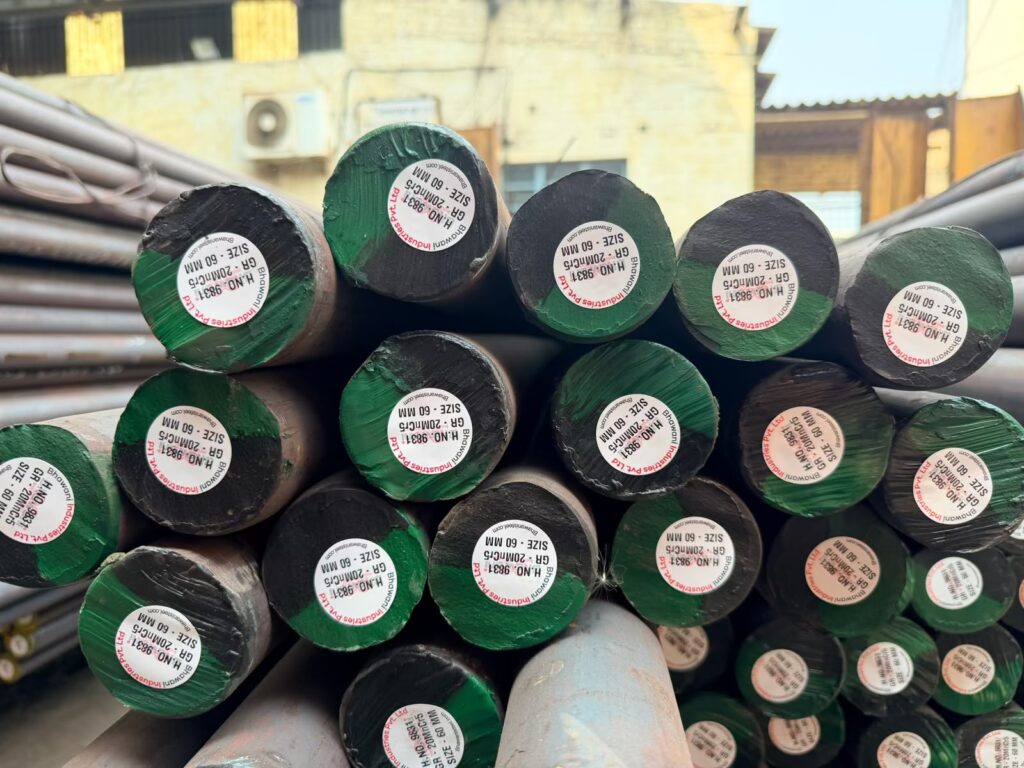 Green-coded round bars stacked in the stockyard