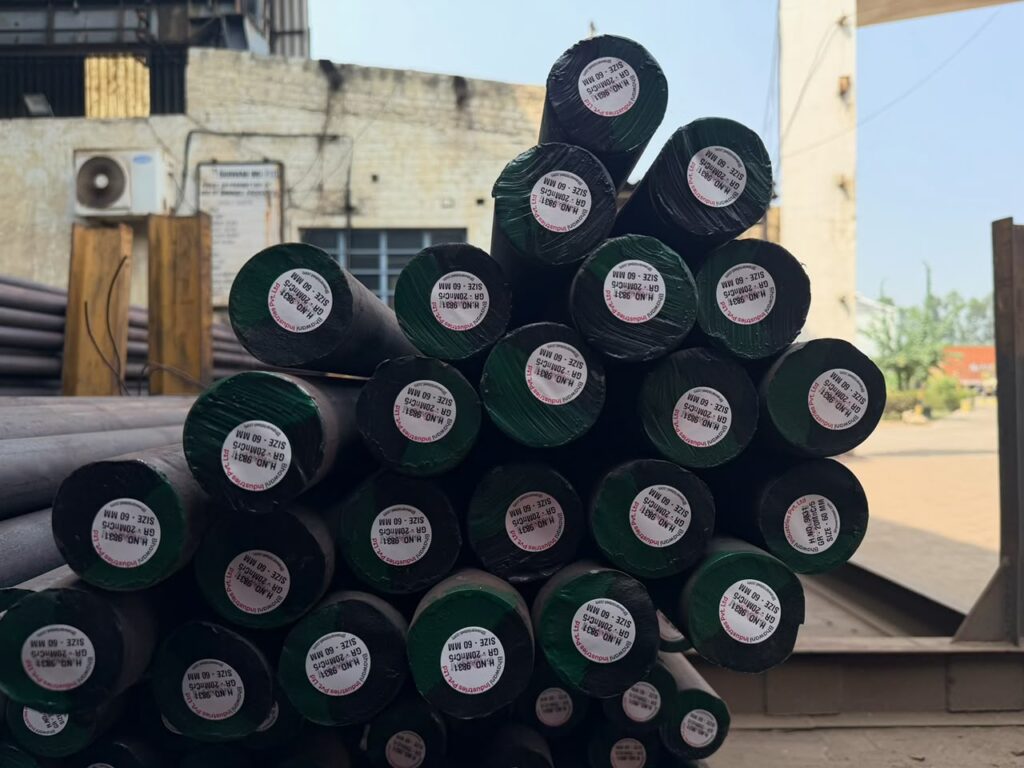 Stack of green-coded round bars in the yard