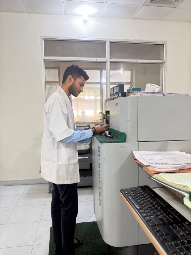 Lab technician loading a sample into the spectrometer