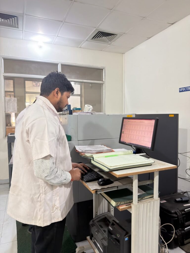 Technician recording results at the analysis workstation