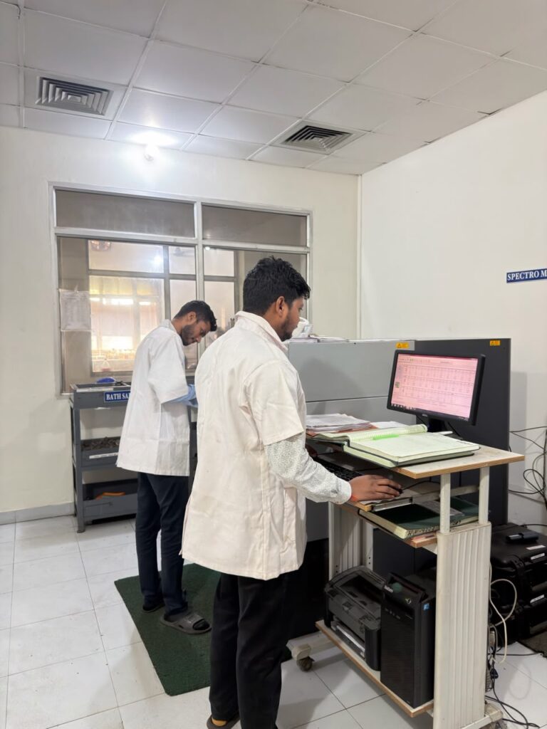 Two technicians at the spectrometer workstation