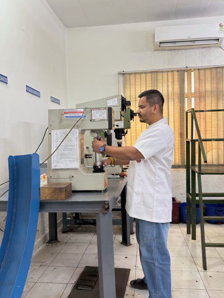 Technician operating a hardness tester